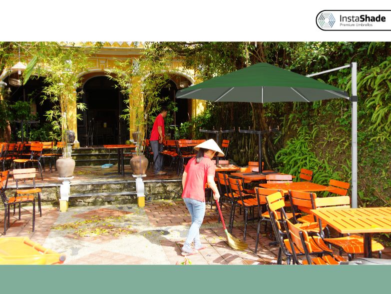 Green color cantilever umbrella in the Eco Green restaurant
